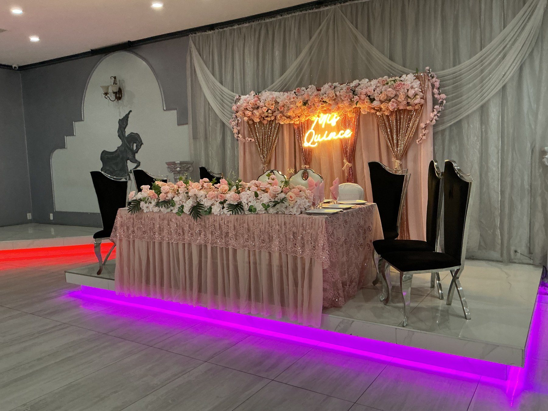 The head table on its glowing stage